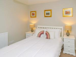 a bedroom with a white bed with two night stands at Number Three - Ukc4965 in Tawstock +13 photos