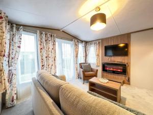 a living room with a couch and a tv at Regent 2 in St. Andrews