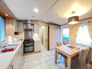 a kitchen with a table and a dining room at Regent 2 in St. Andrews