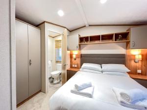 a bedroom with a large bed and a toilet at Regent 2 in St. Andrews +5 photos