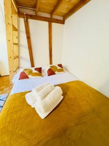 a bedroom with a bed with two towels on it at L'escale Annécienne in Annecy