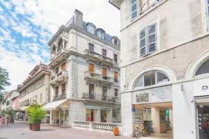 a group of tall buildings on a city street at L'escale Annécienne in Annecy