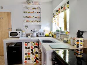 a kitchen with a sink and a microwave at The Stable At Hilltop Farm in Mottisfont