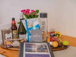 a table with a bunch of products and a bottle of wine at Lilypad in Ringwood