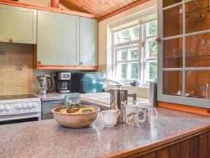 a kitchen with a counter top with a bowl on it at The Stables in Winfrith Newburgh +11 photos