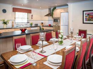 a dining room table with plates and wine glasses at Golden Eagle-Ukc5057 in Aviemore