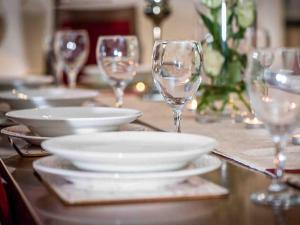 a table with plates and wine glasses on it at Golden Eagle-Ukc5057 in Aviemore