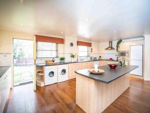 a large kitchen with a large island in the middle at Golden Eagle-Ukc5057 in Aviemore +8 photos