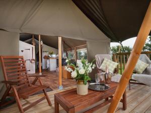 a tent with a table and chairs on a deck at 1 Lower Keats Glamping - Ukc4746 in Chardstock