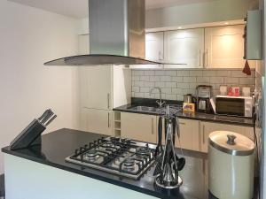 a kitchen with a stove top oven in a kitchen at Raven Wing 17 - Ukc4882 in Fort Augustus