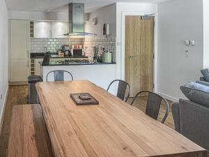 a kitchen and a wooden table in a living room at Raven Wing 17 - Ukc4882 in Fort Augustus