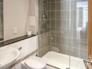 a bathroom with a shower and a toilet and a sink at Raven Wing 17 - Ukc4882 in Fort Augustus +5 photos