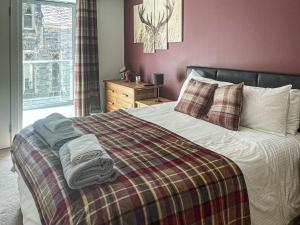 a bedroom with a bed with towels on it at Raven Wing 17 - Ukc4882 in Fort Augustus