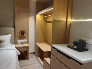 a small room with a bed and a closet at The Bansara Royal in Kātoya