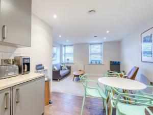 a kitchen and living room with a table and chairs at 6 Eastgate -Uk34289 in Andover