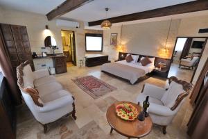 a large living room with a bed and a table at A La Mode Cappadocia in Göreme