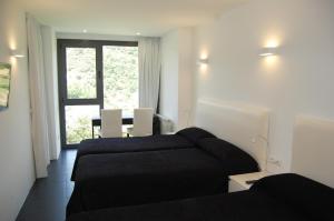 Postel nebo postele na pokoji v ubytování Hostal Tres Campanas