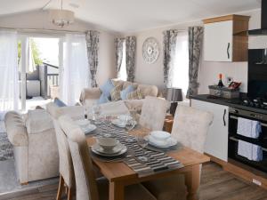 a living room with a table and a couch at Herdwick Lodge - Uk3426 in Newton on the Moor