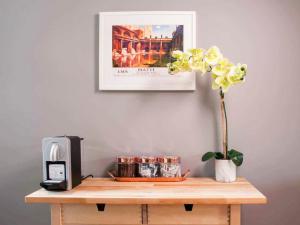 a table with a plant and a picture on the wall at Broad Street in Bath
