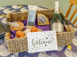 a basket filled with eggs and a bottle of wine at Ivy Cottage - Uk35243 in Llanfyrnach