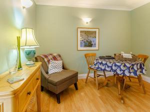 a living room with a table and a chair at Ivy Cottage - Uk35243 in Llanfyrnach +15 photos