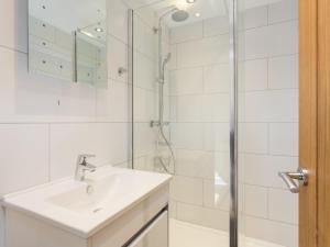 a white bathroom with a sink and a shower at 1 Monkbar Mews - Uk2690 in York