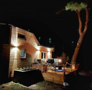 a brick house with a deck at night at Ferien im Tiny House in Stuer +11 photos