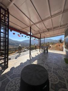 a patio with a table and a view of the mountains at Mountview guest house in Mukteshwar