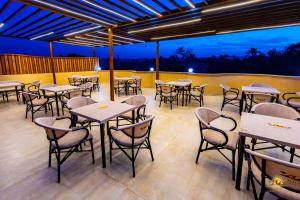 an empty restaurant with tables and chairs at night at Khofo pyramids view inn in Cairo +36 photos