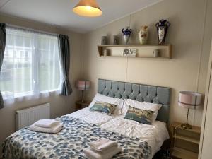 a bedroom with a bed with towels on it at Flamingo's Rest - Uk3348 in Newton on the Moor