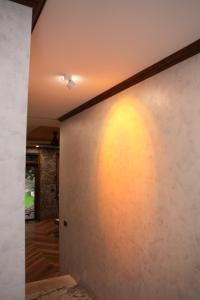 a hallway with a stone wall with a ceiling at SENVIBE Resort in Vằn Trinh