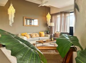a living room with a couch and a table at Penthouse - Sea view, Private roof top pool, Golf in Roches Noires