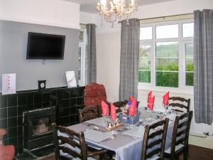 a dining room with a table and a fireplace at Bevan House in Llansaintfraed in Elvel +20 photos