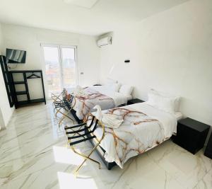 two beds in a room with white walls at BeB VillaReal in Balvano