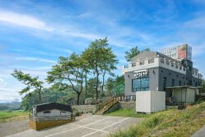a building on the side of a hill at Busan Mandiga Pool Villa in Busan