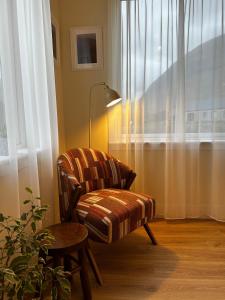 a chair and a table in a room with a window at Auch - Cottages in Bridge of Orchy