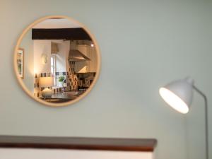 a mirror reflection of a living room with a lamp at Number Eight - Ukc4971 in Tawstock