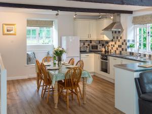 a kitchen with a table and chairs in a room at Number Eight - Ukc4971 in Tawstock