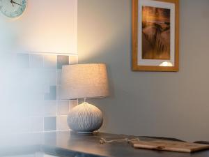 a lamp sitting on a table in a room at Number Eight - Ukc4971 in Tawstock