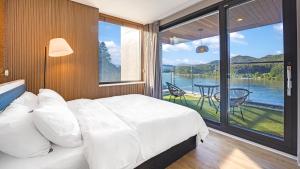 a bedroom with a bed and a large window at Gapyeong Laputa Resort in Gapyeong