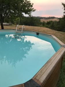 a swimming pool with a wooden fence around it at Chalet à Bazian in Bazian