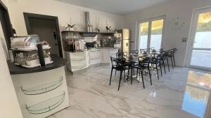 a kitchen and dining room with a table and chairs at BeB VillaReal in Balvano