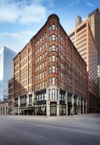 a large brick building in the middle of a city at Hilton Pennywell St Louis at the Arch in Saint Louis