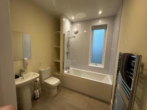 a bathroom with a toilet and a sink and a shower at Auch - Cottages in Bridge of Orchy +16 photos