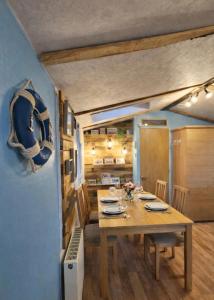 a dining room with a wooden table and chairs at Riverscape Northumberland in Ashington