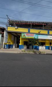 a yellow and blue building on the side of a street at Isla Boracay Inn in Boracay