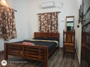 a bedroom with a wooden bed and a mirror at Sandy Steps in Varkala +7 photos