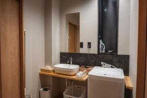 a bathroom with a sink and a mirror at 月詠 Tsukuyomi in Fujikawaguchiko +31 photos