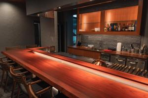 a bar in a restaurant with a counter and chairs at 月詠 Tsukuyomi in Fujikawaguchiko