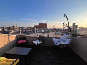 a balcony with two chairs and a swing at GIRLSTEL Wrocław - Girls ONLY Space in Wrocław